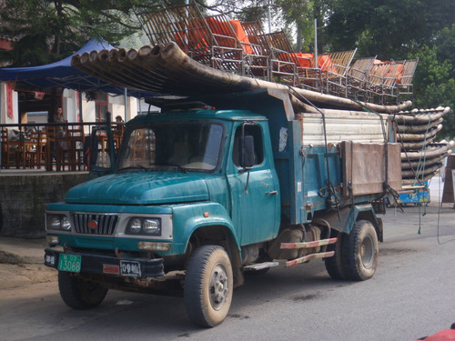 Truck carrying small tour boats.